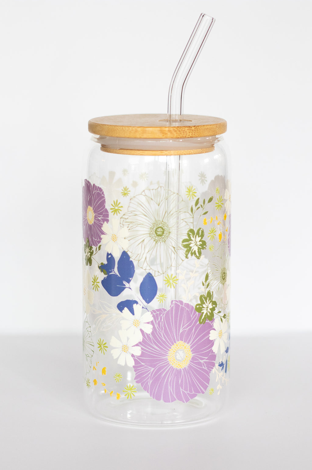 Floral-patterned can glass with a bamboo wooden lid and a glass straw on a white background.
