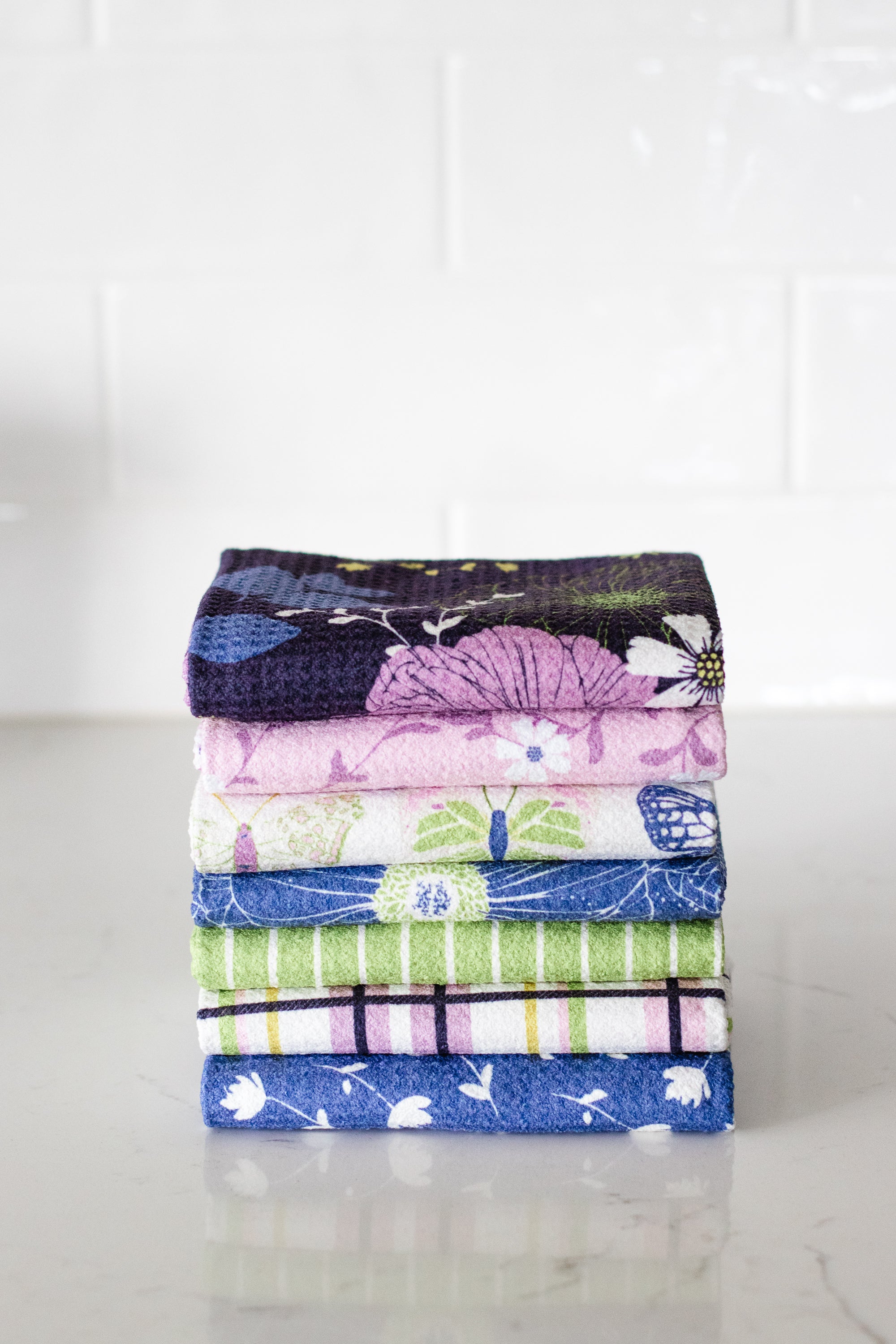 Spring kitchen towel set of floral waffle weave towels against white background.