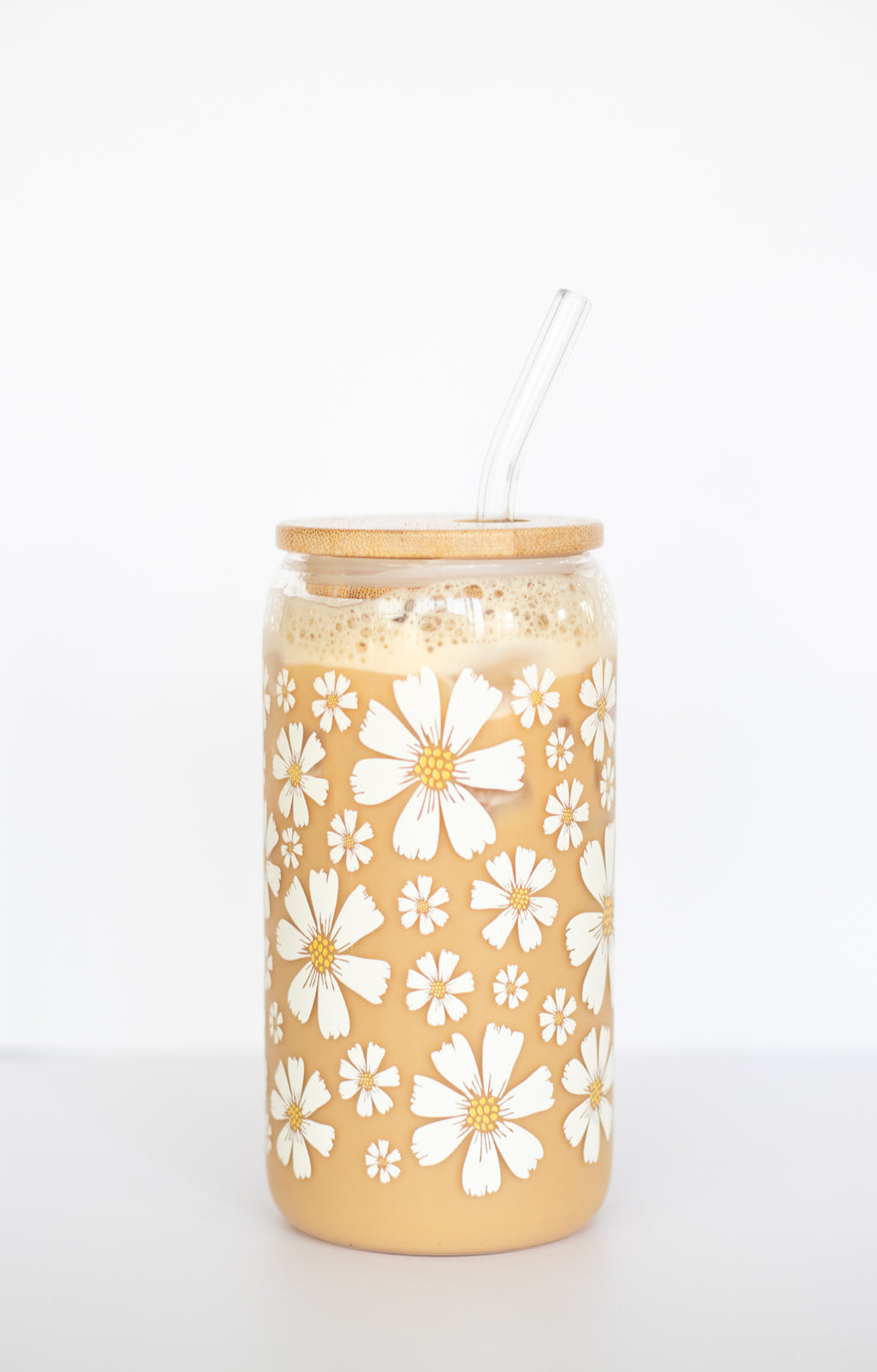Can glass with a white floral pattern against a white background.