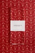 A folded red waffle-weave kitchen tea towel with a repeating hand-drawn white longhorn skull pattern, featuring a white paper belly band label in the center that reads 'ASPECT HOME GOODS' and 'Kitchen Tea Towel', laid on a matching background.