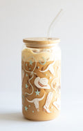 Glass tumbler with wooden lid and straw featuring cowgirl and longhorn design on a white background