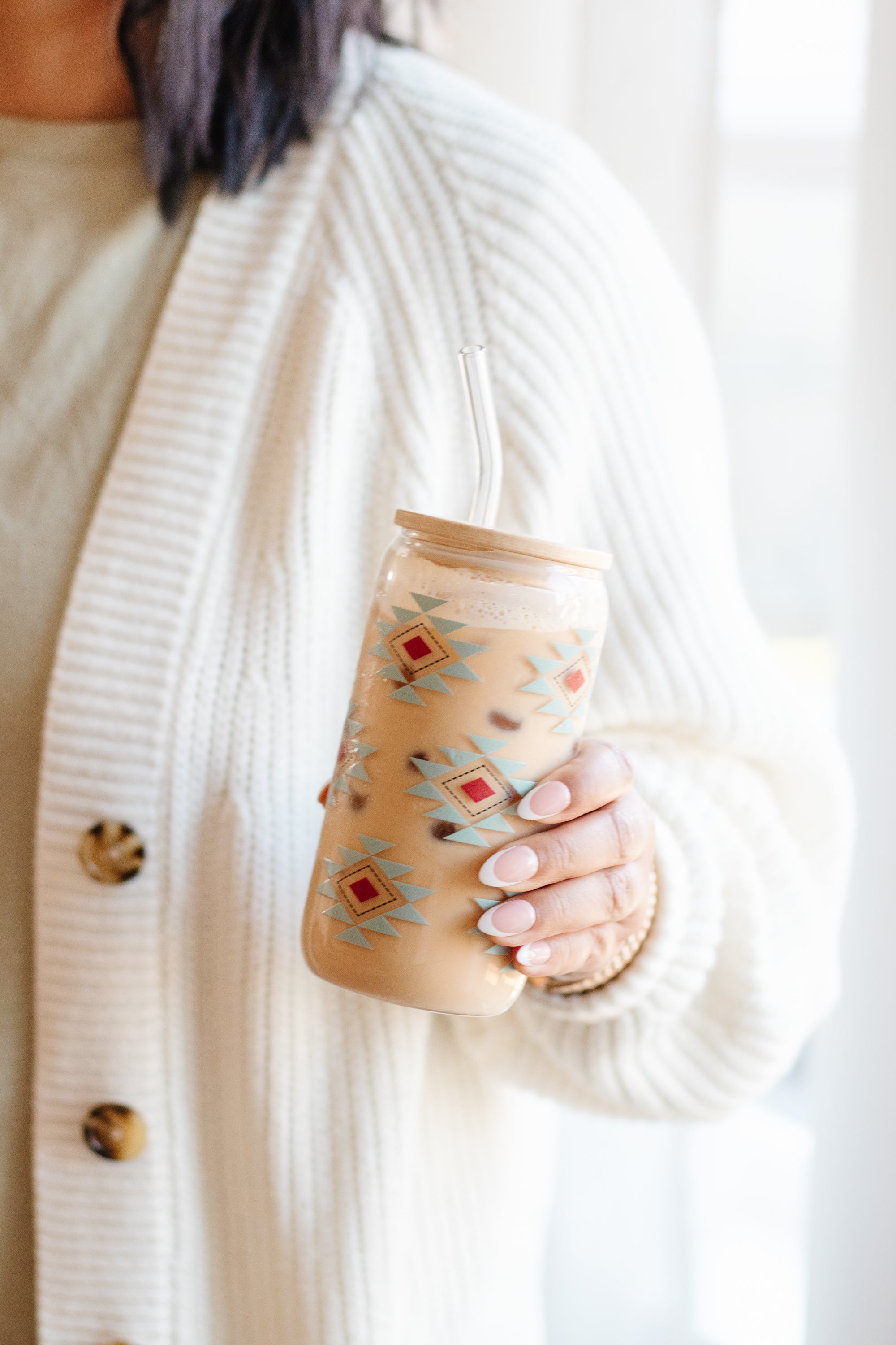Person holding a southwestern geometric-patterned can glass