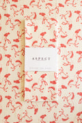 A folded waffle-weave kitchen tea towel with a red running horses pattern on a cream background, featuring a white paper belly band label in the center that reads 'ASPECT HOME GOODS' and 'KITCHEN TEA TOWEL', laid on a background of the same pattern.